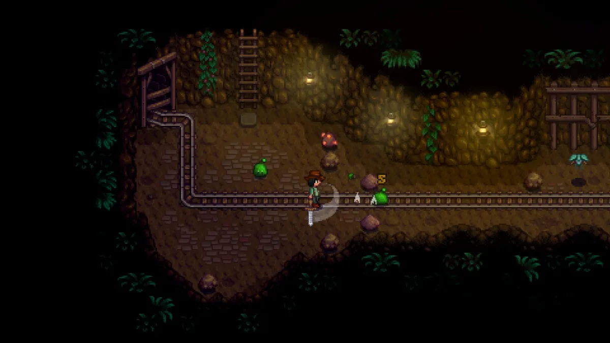Stardew Valley’de madende yeşil yaratıklara kılıçla saldıran çiftçi